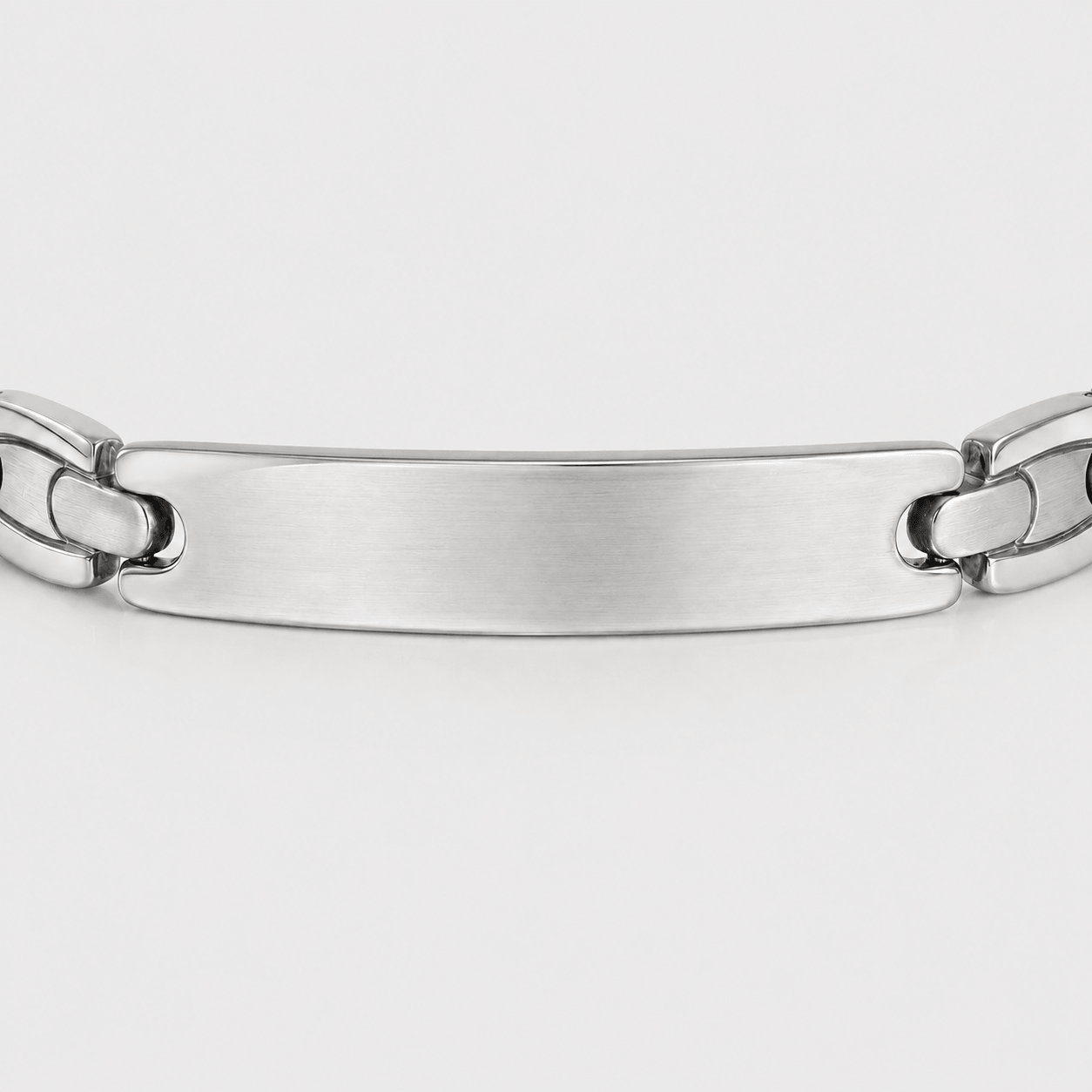 Silver chain bracelet on a light gray background