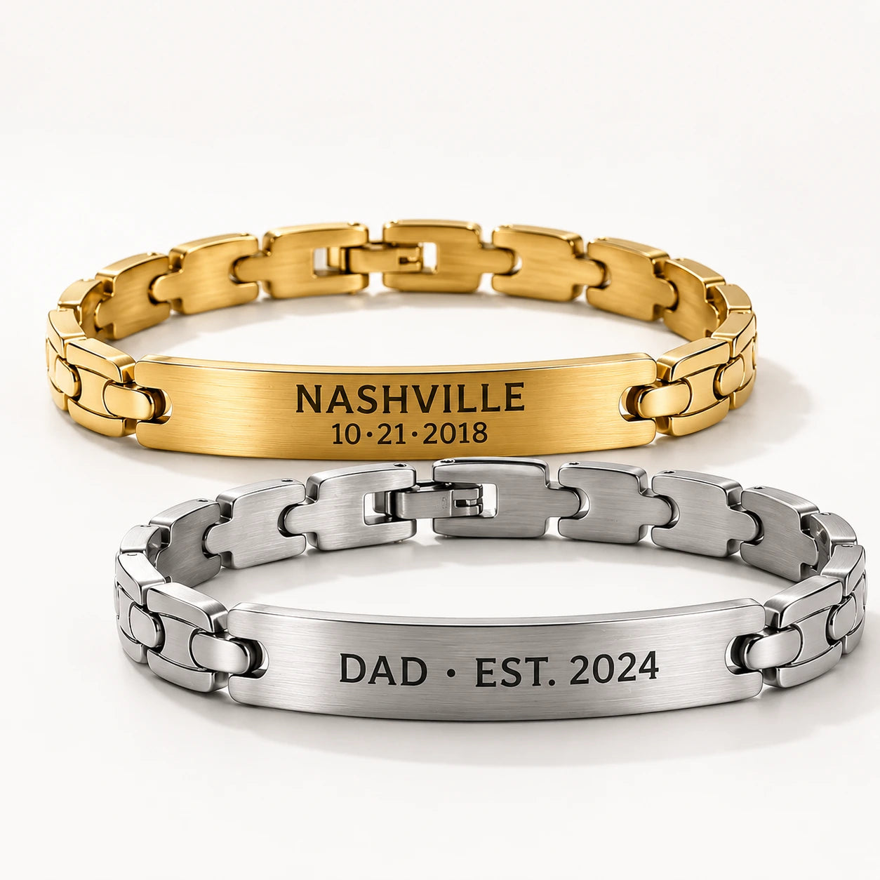 Gold and silver bracelets with engraved text on a white background