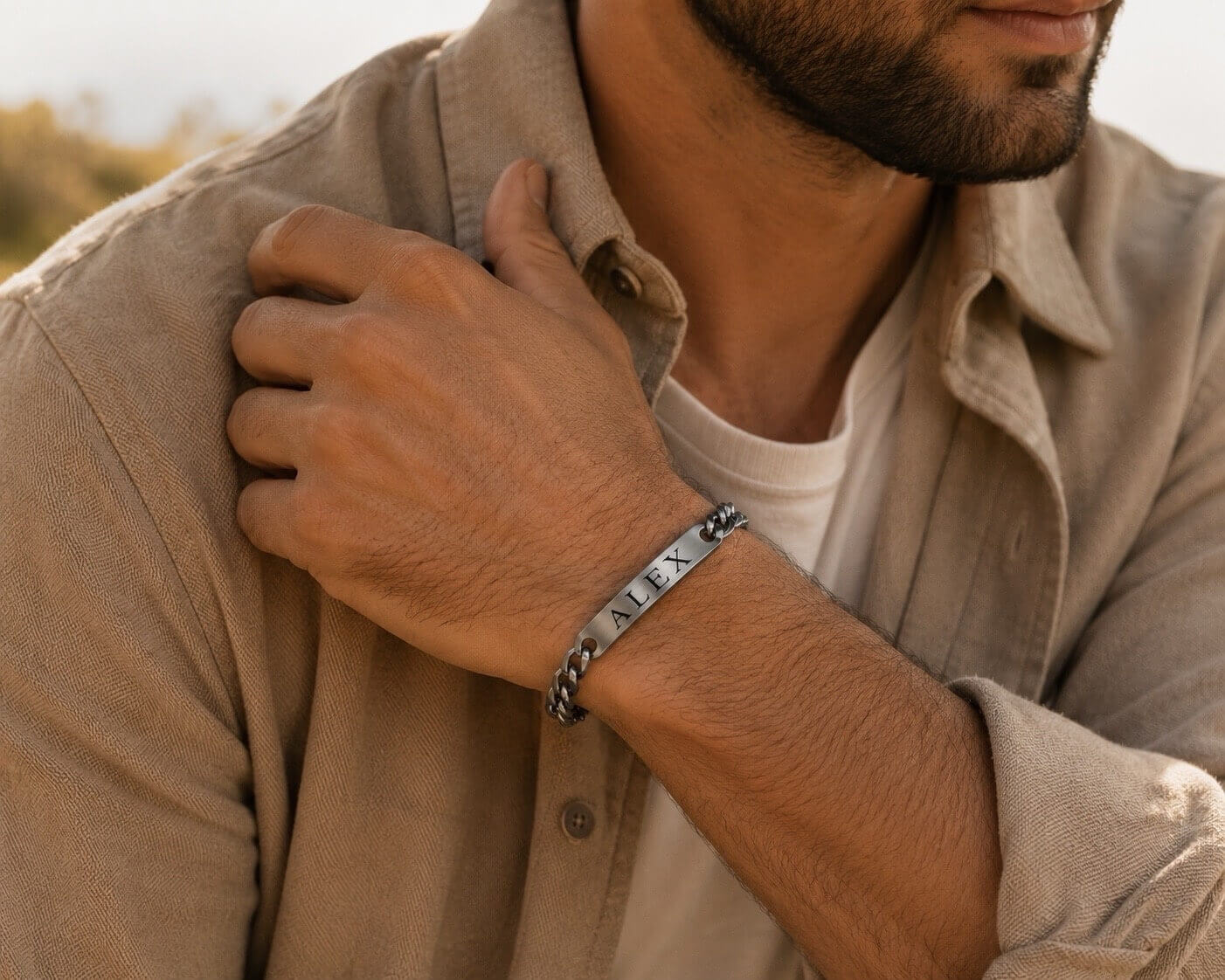 Man wearing a bracelet on his wrist with a neutral background